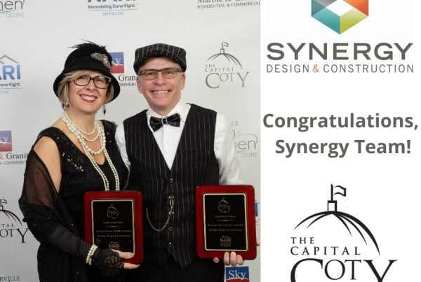 Synergy owners smiling with awards