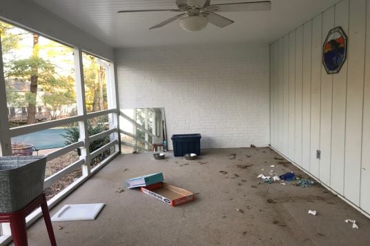 enclosed patio with clutter before remodel