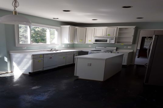 kitchen with white cabinets and black floor