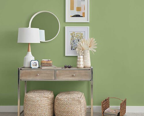 close up of side table with guacamole colored walls