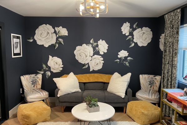 seating area with floral paint on the walls